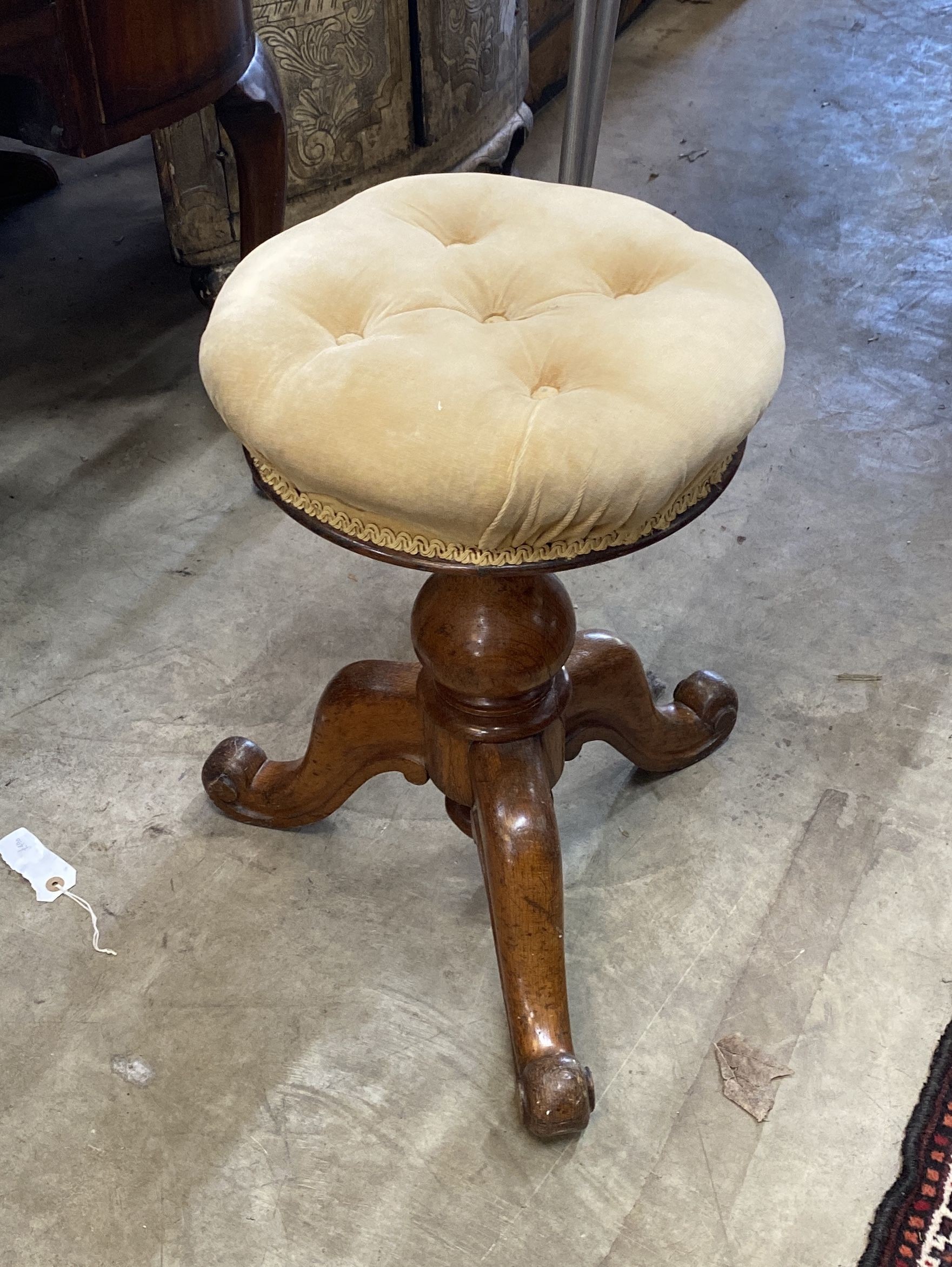 A Victorian oak revolving piano stool